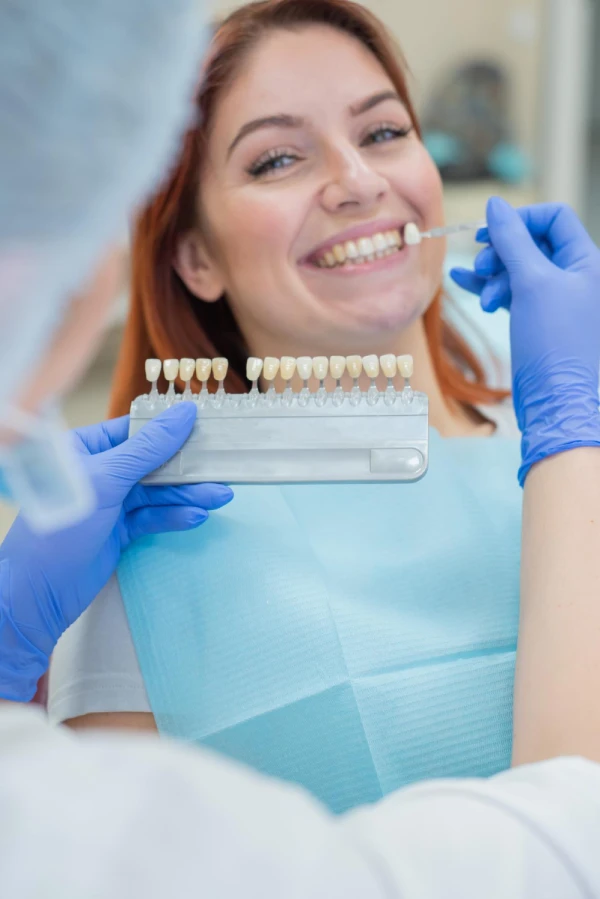 Patient select the color of the veneers in the dentist chair
