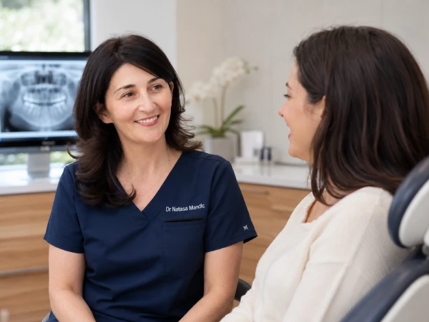 Dr. Mandic-Kuljic speaking with a patient in a modern dental consultation room
