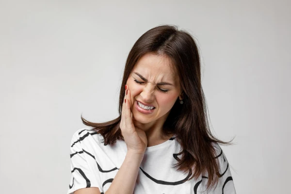 Young sad woman suffering from tooth sensitivity